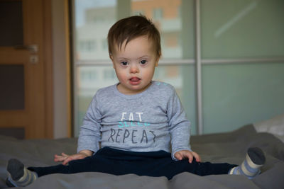 Portrait of boy sitting at home