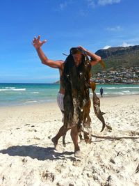 Full length of man with at beach against sky