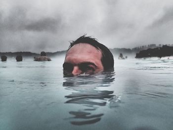 Portrait of man swimming in geyser