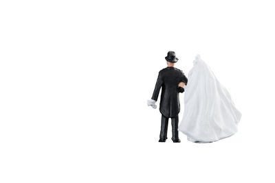 Rear view of couple walking against white background