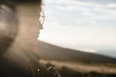 Close up of a young man explorer carrying his camera equipment and sun