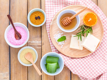 High angle view of various spa products on wooden table