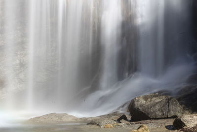 Scenic view of waterfall against sky