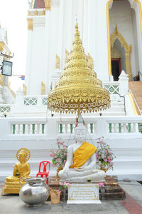 Buddha statue against temple