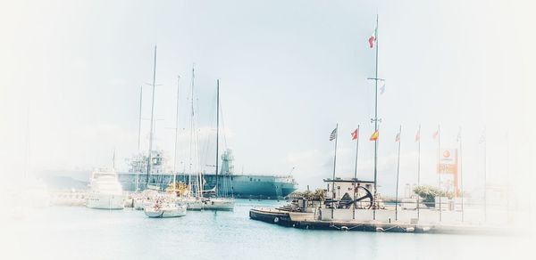 Sailboats in sea against sky