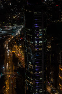 High angle view of illuminated buildings in city at night