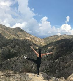 Full length of man standing on mountain against sky