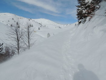 Scenic view of snow covered mountains against sky