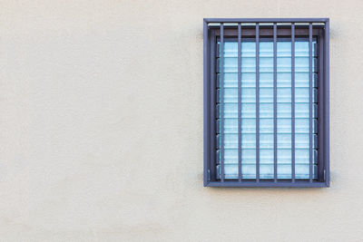 Window on white wall of building