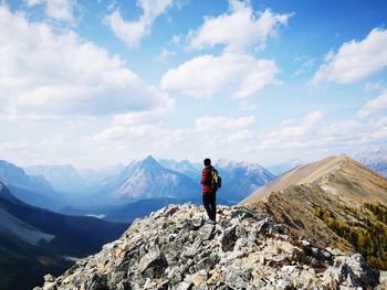 When nature make you feel small, a picture of a human being on top of thetent ridge trail.