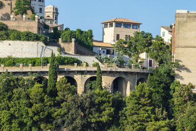 Arch bridge and buildings against sky