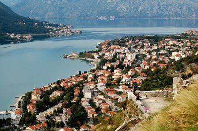 High angle view of town by lake against sky