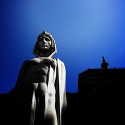 Low angle view of statue against clear blue sky