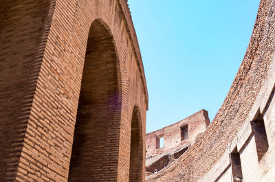 Low angle view of colosseum against clear sky