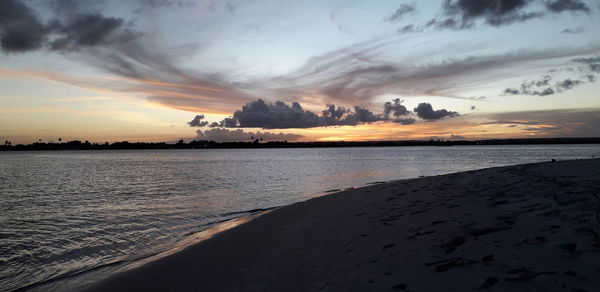 Scenic view of beach against sky during sunset