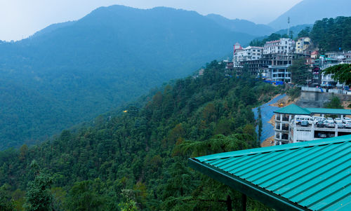 High angle view of swimming pool by buildings against mountains