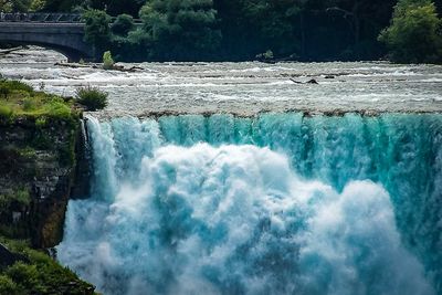 Scenic view of waterfall against sky