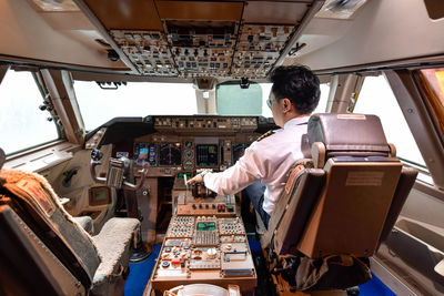 Rear view of man working in bus