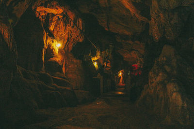 View of illuminated building through cave