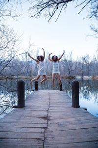 Women standing on wooden structure in winter