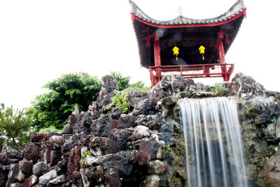 Low angle view of statue against temple