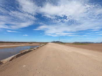 Road by land against sky