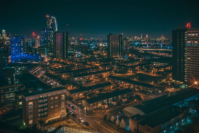 High angle view of city lit up at night