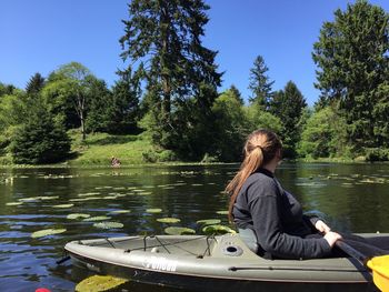 Woman kayaking in lake