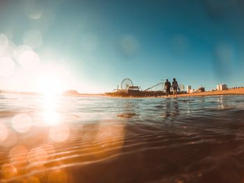 People on beach against sky