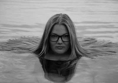 Portrait of beautiful young woman in water