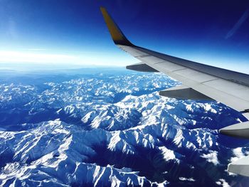 Cropped image of airplane flying over landscape