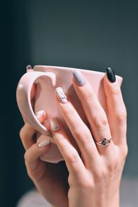 Close-up of woman hand on finger against black background