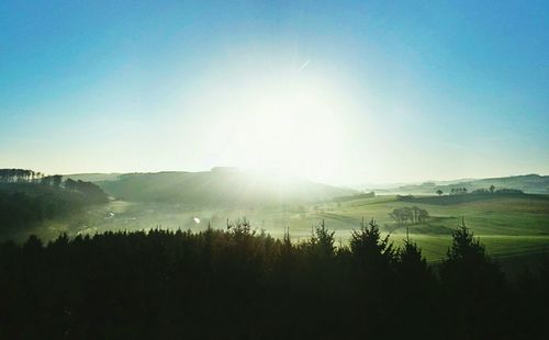 Sun shining over landscape