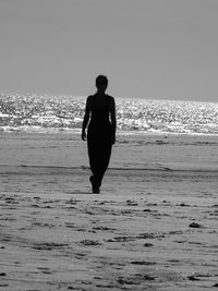 Rear view of woman on beach