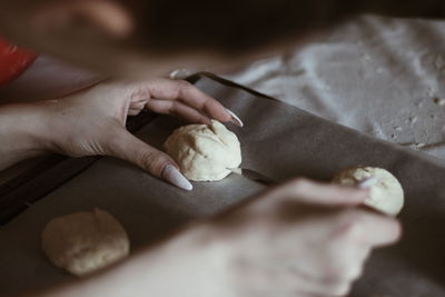 Close-up of hand holding ice cream on table