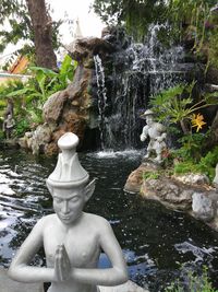 Statue of fountain against rocks