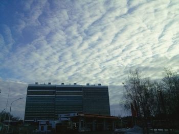 Low angle view of building against cloudy sky