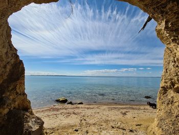 Scenic view of sea against sky from cave