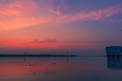 Scenic view of lake against romantic sky at sunset