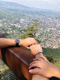 High angle view of woman hand holding cityscape