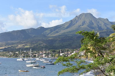 Scenic view of bay and mountains against sky