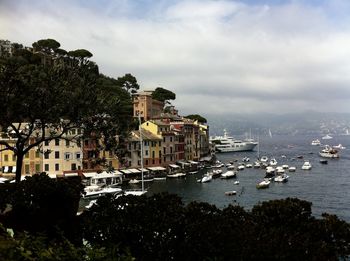 View of buildings in city against cloudy sky