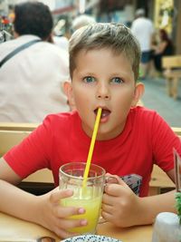 Portrait of boy holding glass of drink