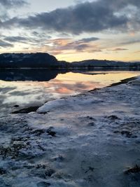 Scenic view of beach against sky during sunset