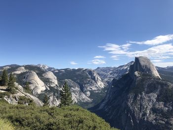 Scenic view of mountains against blue sky