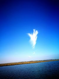 View of calm blue sea against clear sky