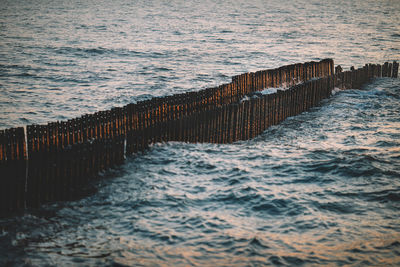 Wooden posts on sea