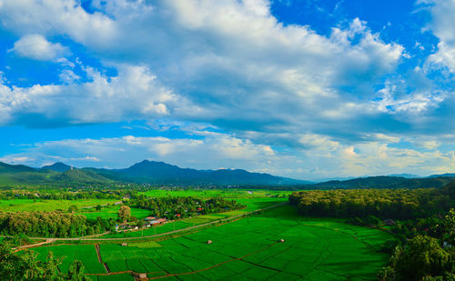 Scenic view of landscape against cloudy sky