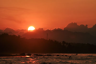 Scenic view of silhouette mountains against sky during sunset