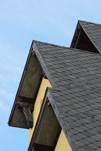Low angle view of traditional windmill against sky